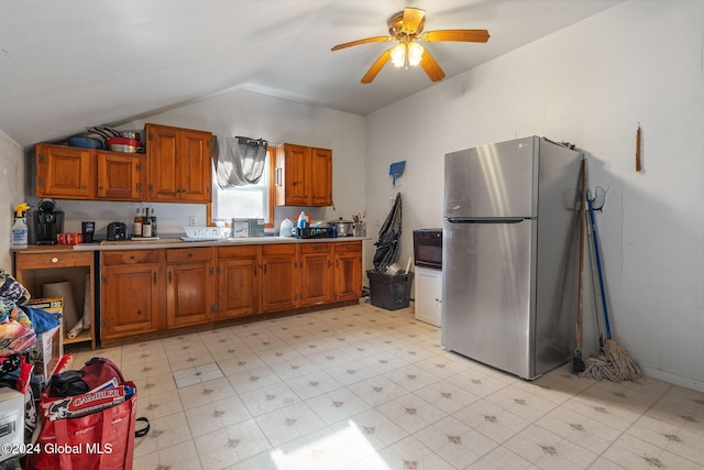 16 Main St, Worcester, NY 12064 - kitchen with freestanding refrigerator, vaulted ceiling, brown cabinets, a ceiling fan, and light countertops