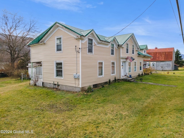 16 Main St, Worcester, NY 12064 - rear view of house featuring a lawn and metal roof