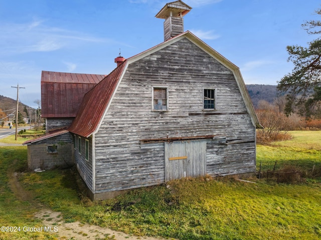 16 Main St, Worcester, NY 12064 - view of side of property featuring a barn, a gambrel roof, an outdoor structure, and a chimney