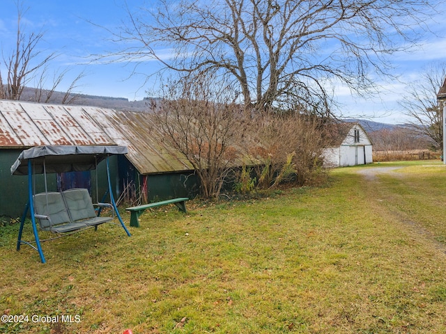 16 Main St, Worcester, NY 12064 - rear view of property featuring an outbuilding and a yard
