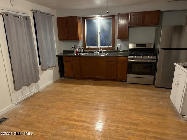 16 Main St, Worcester, NY 12064 - kitchen featuring stainless steel appliances, a sink, dark countertops, and light wood-type flooring