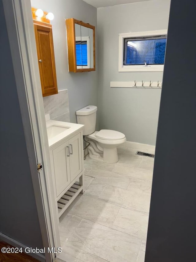 16 Main St, Worcester, NY 12064 - half bath featuring vanity, toilet, and baseboards