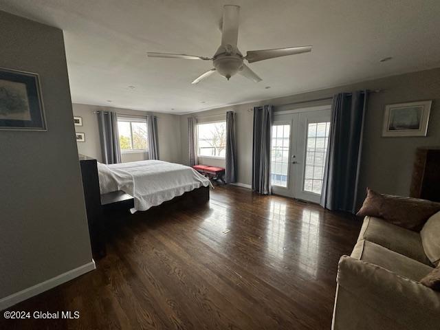 bedroom with ceiling fan, dark hardwood / wood-style floors, access to outside, and french doors