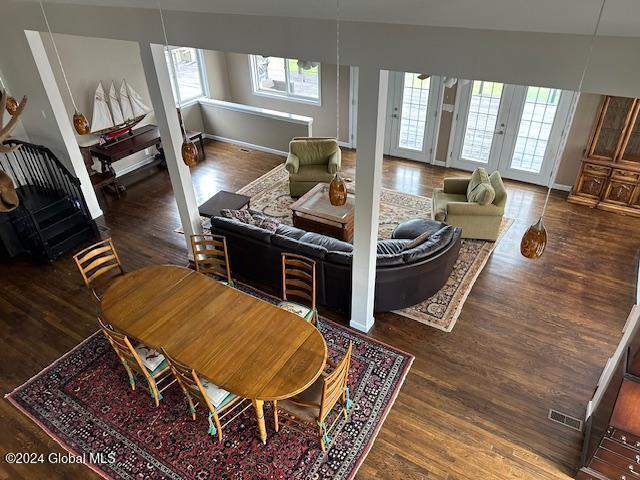 living room featuring dark hardwood / wood-style flooring, plenty of natural light, and french doors