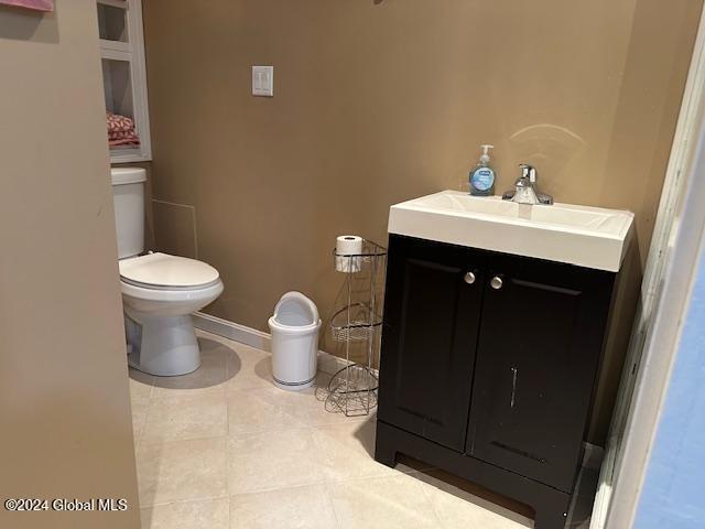 bathroom featuring tile patterned floors, vanity, and toilet