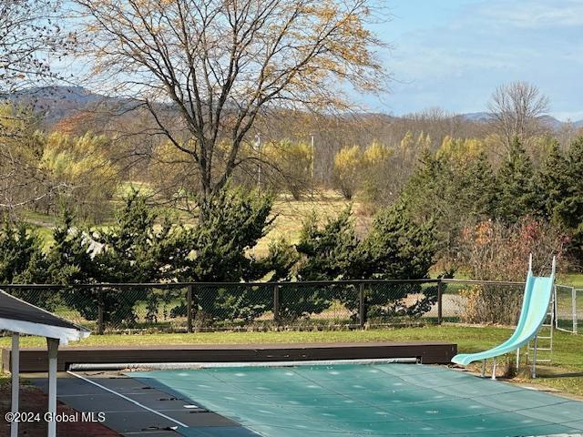 view of swimming pool featuring a mountain view and a water slide