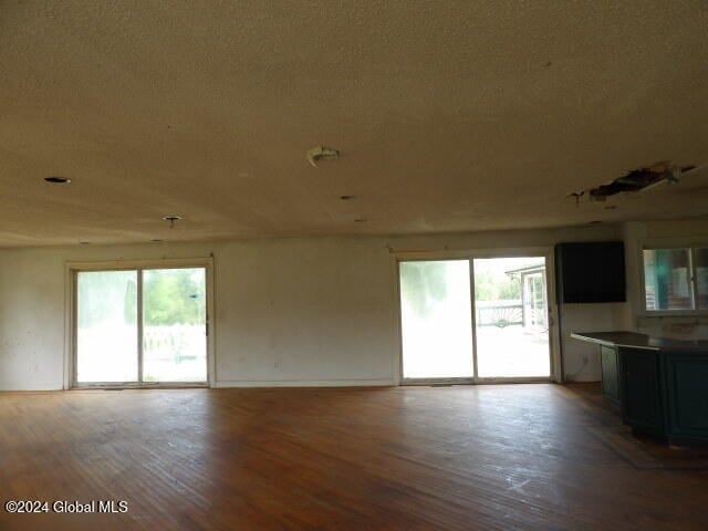 unfurnished living room featuring hardwood / wood-style flooring