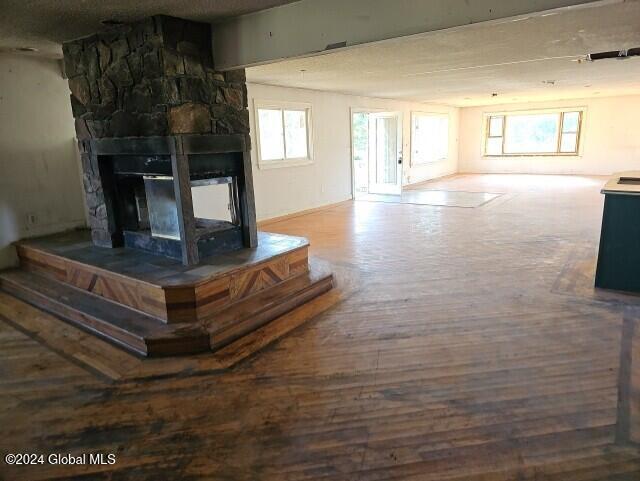 unfurnished living room featuring a healthy amount of sunlight and a fireplace