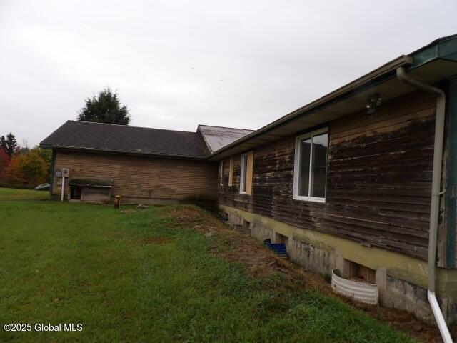 view of property exterior with a yard