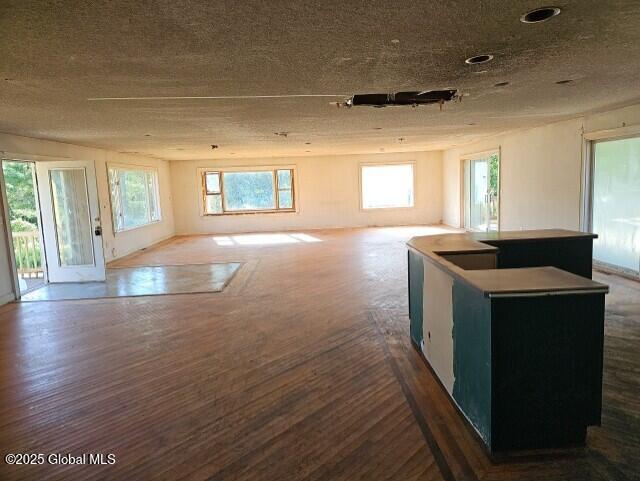 kitchen featuring plenty of natural light, wood-type flooring, and a center island