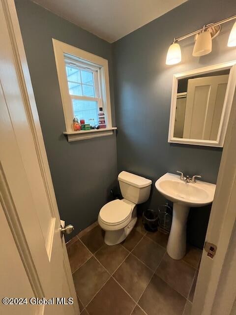 bathroom featuring sink, tile patterned flooring, and toilet