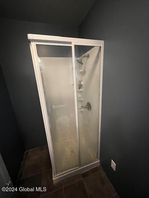 bathroom with tile patterned flooring and an enclosed shower