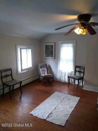 sitting room with dark hardwood / wood-style floors, vaulted ceiling, ceiling fan, and a healthy amount of sunlight