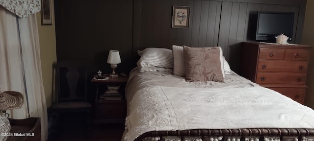 bedroom with wooden walls