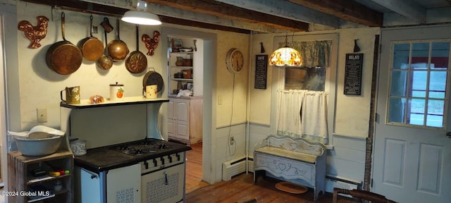 kitchen with beamed ceiling, hardwood / wood-style floors, pendant lighting, and a baseboard heating unit