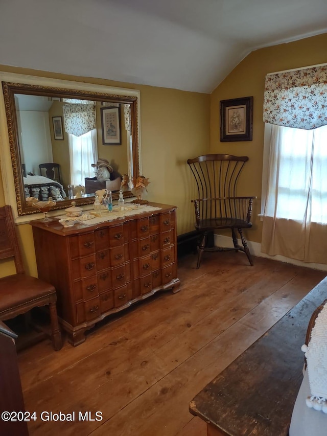 sitting room with hardwood / wood-style floors and lofted ceiling