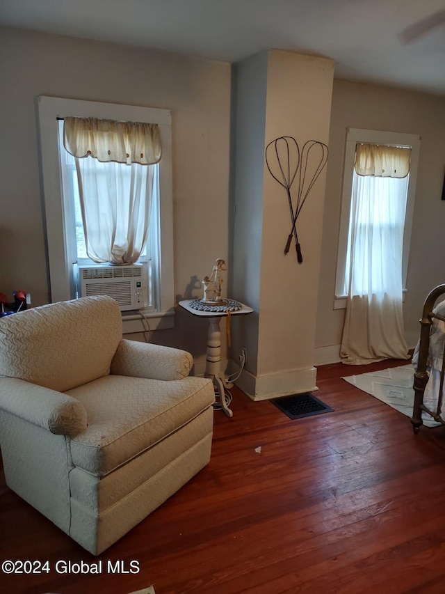 living area featuring hardwood / wood-style floors and cooling unit