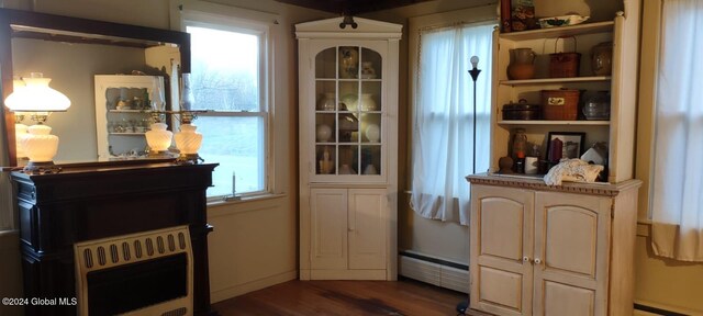 entryway with dark hardwood / wood-style floors, heating unit, and a baseboard heating unit