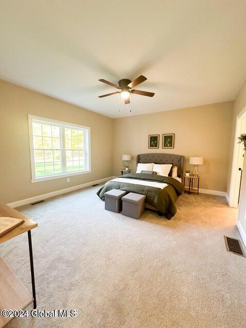 carpeted bedroom featuring ceiling fan