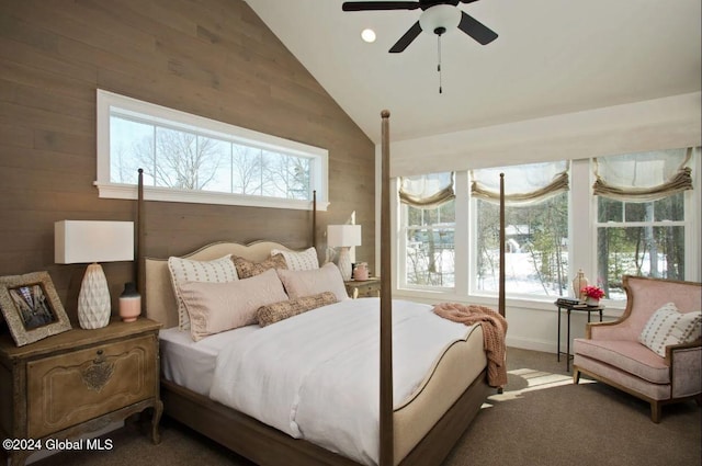 carpeted bedroom featuring ceiling fan, wooden walls, and high vaulted ceiling