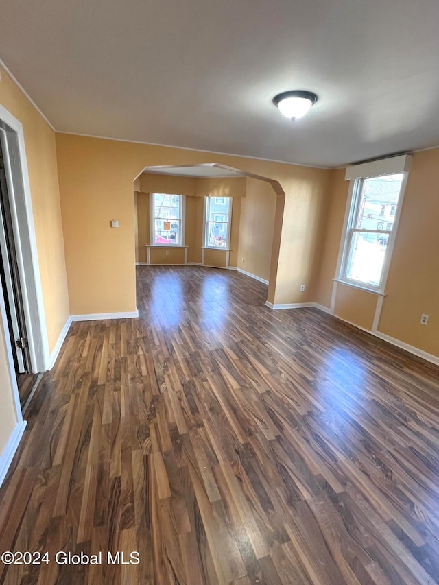 spare room featuring dark wood-type flooring