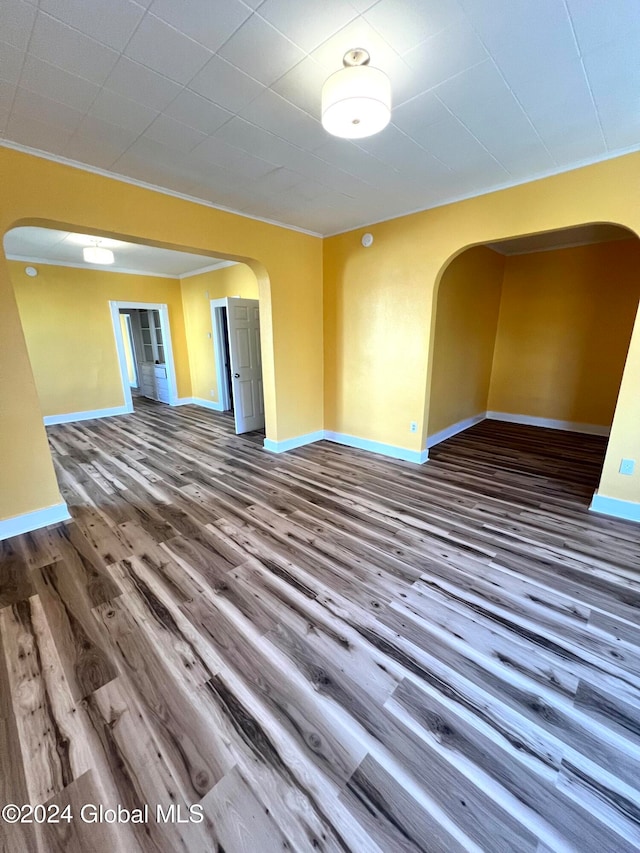 spare room with hardwood / wood-style floors and ornamental molding