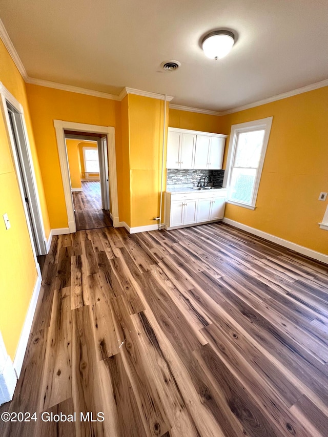 kitchen featuring backsplash, crown molding, sink, white cabinets, and dark hardwood / wood-style floors