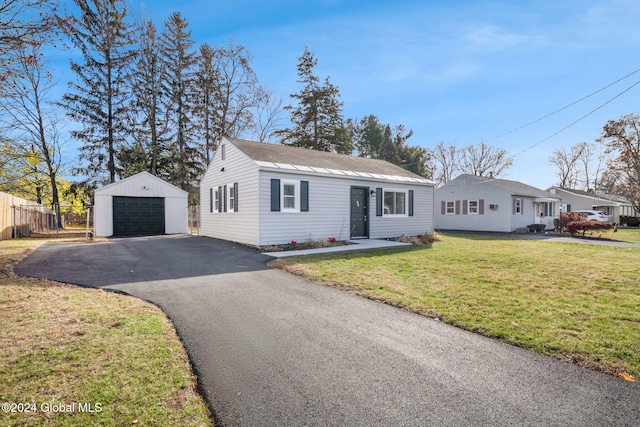 view of front facade with a garage, an outbuilding, and a front yard