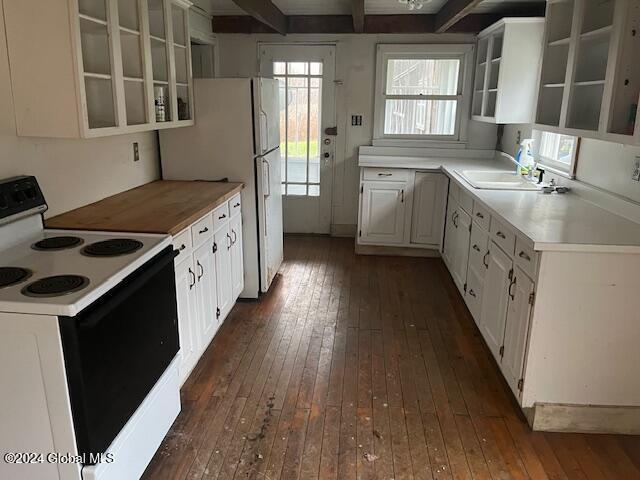 kitchen with sink, beamed ceiling, dark hardwood / wood-style floors, white appliances, and white cabinets