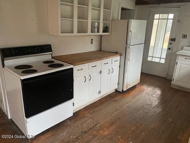 kitchen featuring white cabinetry, dark hardwood / wood-style floors, and white appliances