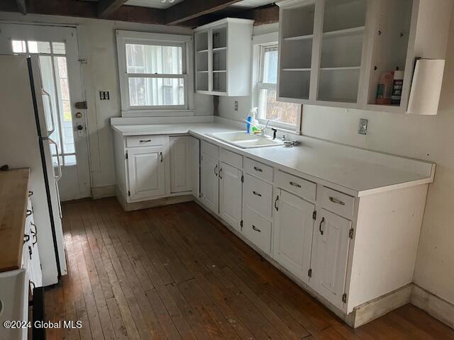 kitchen featuring white refrigerator, white cabinetry, sink, and dark wood-type flooring