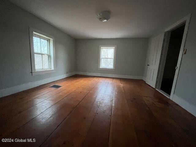 unfurnished room with hardwood / wood-style flooring