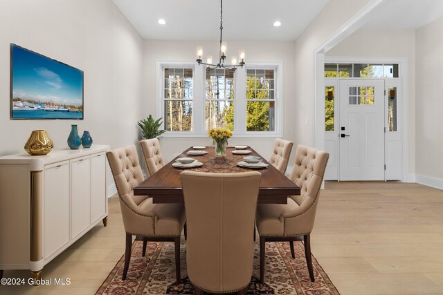 dining space with a chandelier and light hardwood / wood-style floors