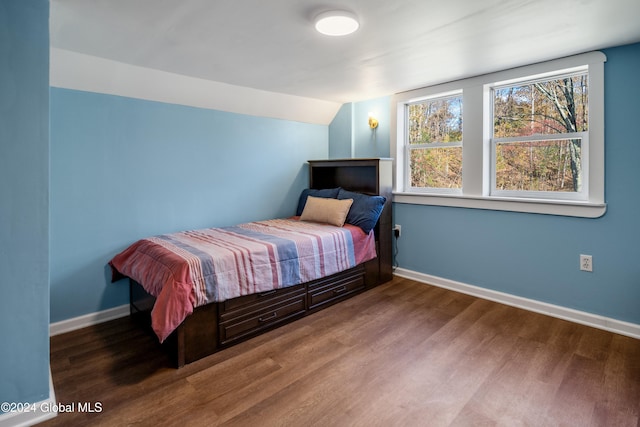 bedroom with hardwood / wood-style floors and vaulted ceiling