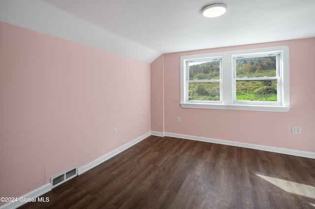 bonus room with dark wood-type flooring and lofted ceiling