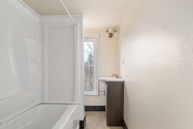 bathroom featuring tile patterned floors, vanity, and tub / shower combination