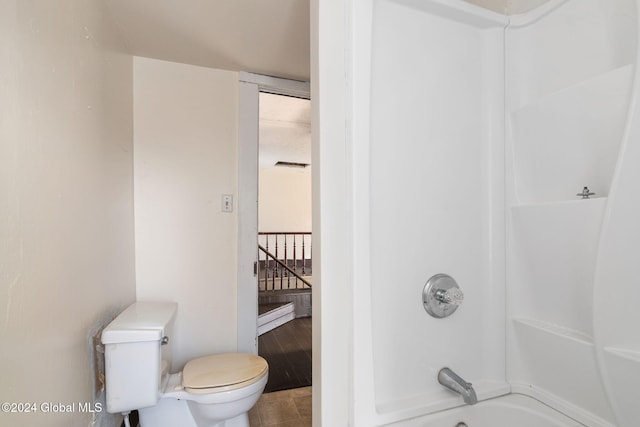 bathroom featuring tile patterned floors, shower / bathtub combination, toilet, and a healthy amount of sunlight