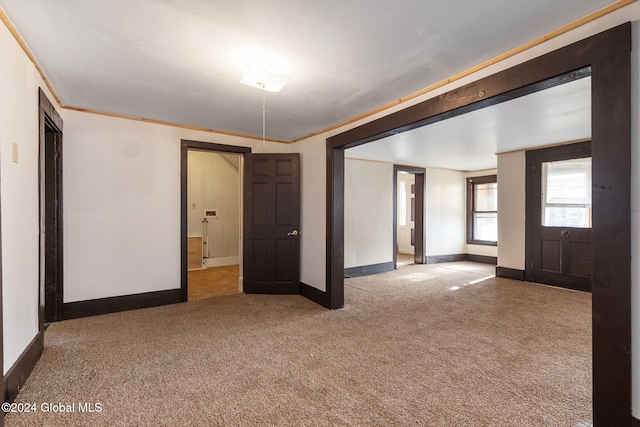 carpeted empty room with crown molding