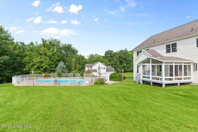 view of yard with a sunroom and a fenced in pool