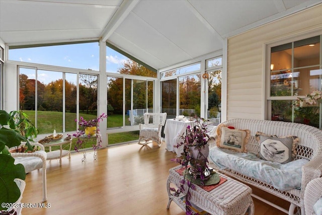 sunroom with vaulted ceiling with beams