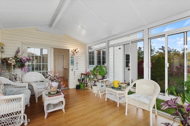 sunroom / solarium featuring lofted ceiling with beams