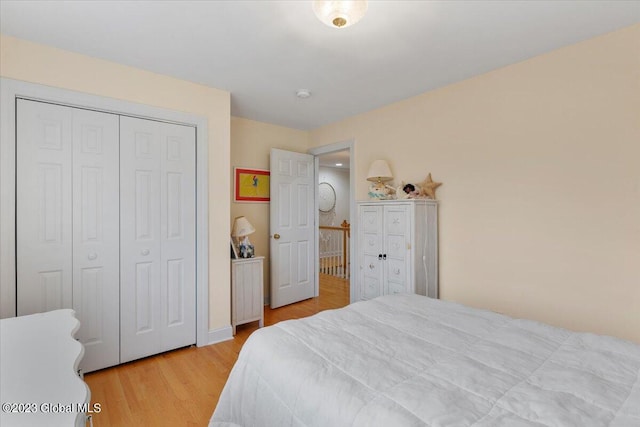 bedroom featuring light hardwood / wood-style flooring and a closet