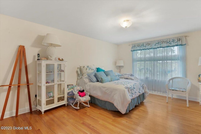 bedroom with hardwood / wood-style flooring