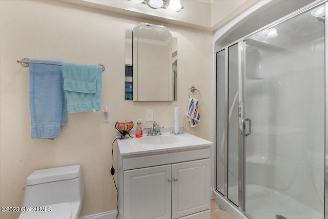 bathroom featuring toilet, vanity, and walk in shower