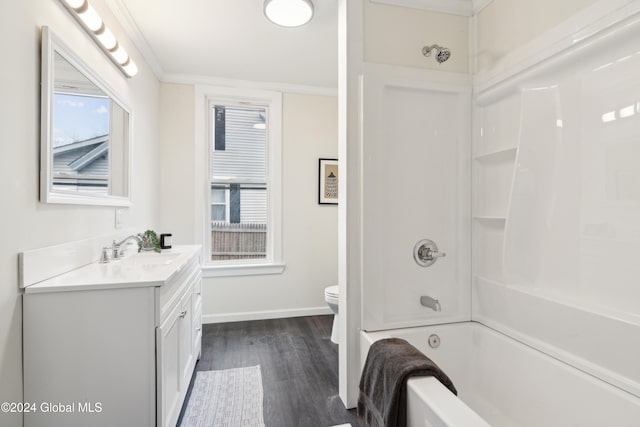 full bathroom featuring vanity,  shower combination, crown molding, wood-type flooring, and toilet