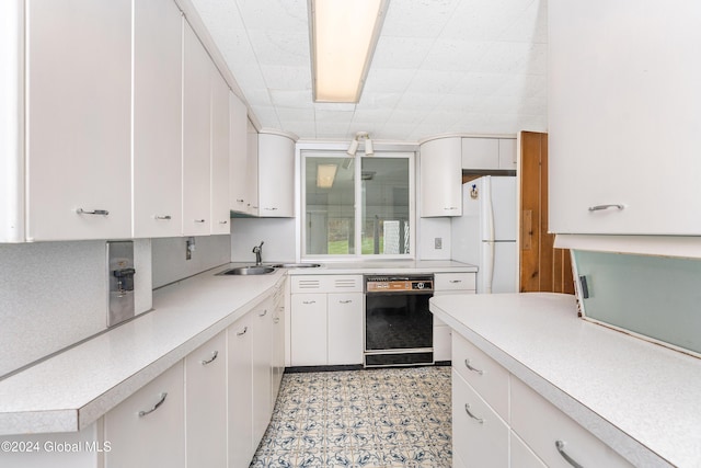 kitchen featuring white cabinetry, dishwasher, and white fridge