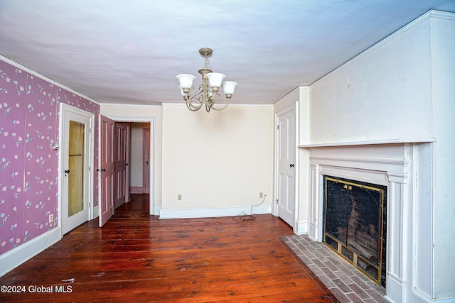 unfurnished living room featuring crown molding, dark hardwood / wood-style floors, and a chandelier