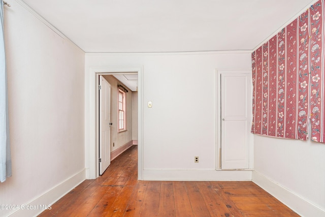 spare room featuring wood-type flooring