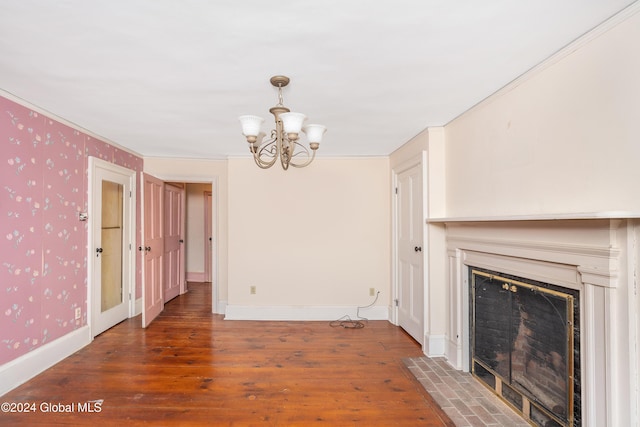 interior space with a notable chandelier, dark wood-type flooring, and ornamental molding