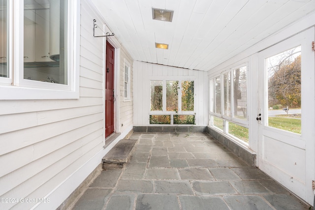 unfurnished sunroom with wood ceiling